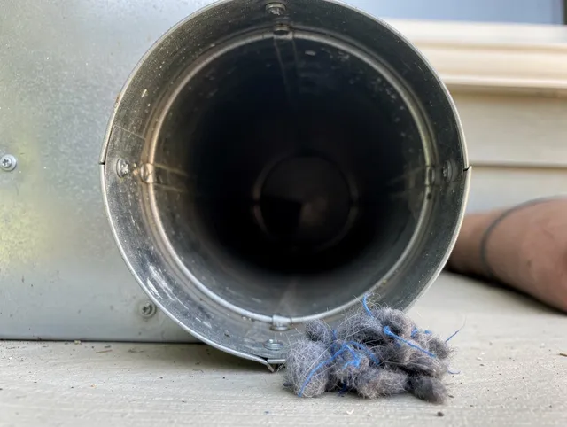 Citrus Dryer Vent Cleaning technician using specialized equipment to clear severe dryer vent blockage in Citrus